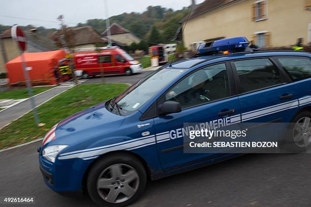 French gendarme arrives in a car at the site where an F18 jet fighter of the Swiss Army crashed earlier on October 14, 2015 in Glamondans, eastern...