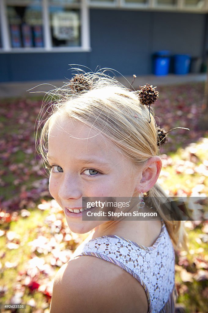 Girl with sycamore tree seed pods in her hair