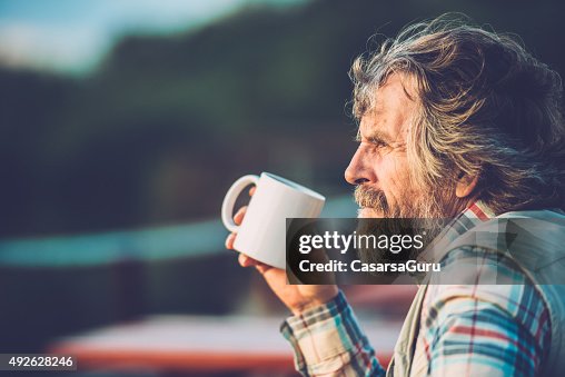 Senior Man Drinking a Coffee or a Tea Outdoors, Close-up Senior Man Drinking a Coffee or a Tea Outdoors, Close-up