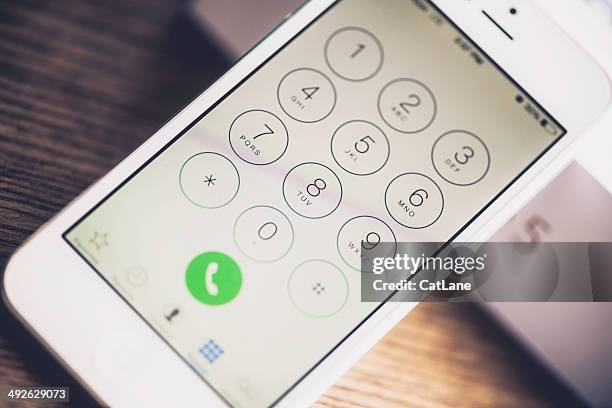 technology: iphone5 showing dial number screen - phone number stock pictures, royalty-free photos & images