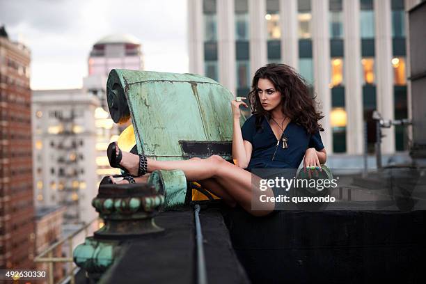 beautiful, sexy young woman fashion model on downtown rooftop, copyspace - beautiful long legs stock pictures, royalty-free photos & images