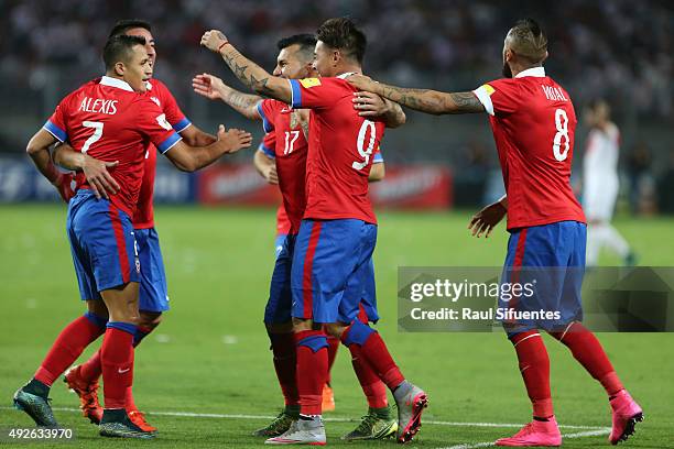 Eduardo Vargas of Chile celebrates with teammates after scoring the fourth goal of his team against Peru during a match between Peru and Chile as...