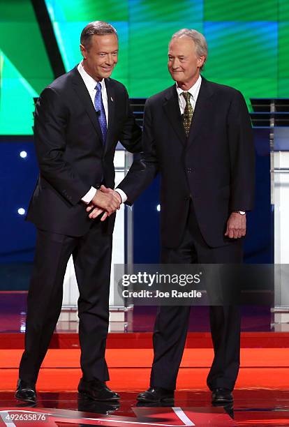 Democratic presidential candidates Martin O'Malley and Lincoln Chafee shake hands as take the stage for a presidential debate sponsored by CNN and...