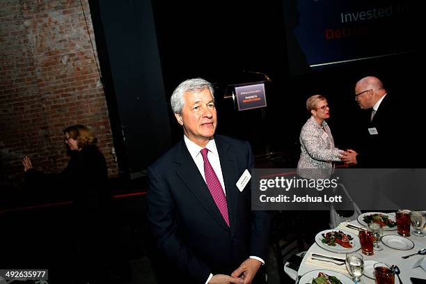 Morgan Chase CEO Jamie Dimon, center, attends a luncheon May 21, 2014 in Detroit, Michigan. Dimon announced during the luncheon that JP Morgan Chase...