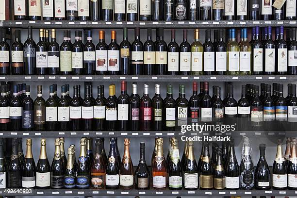 wine bottles in wine shop - wine rack stock pictures, royalty-free photos & images