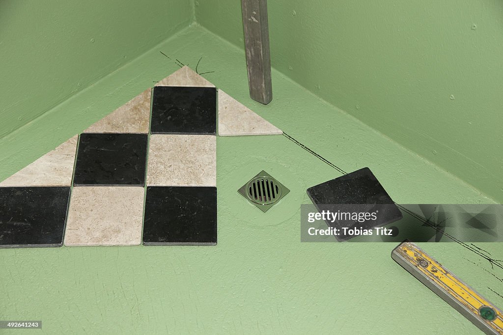 Installing floor tiles