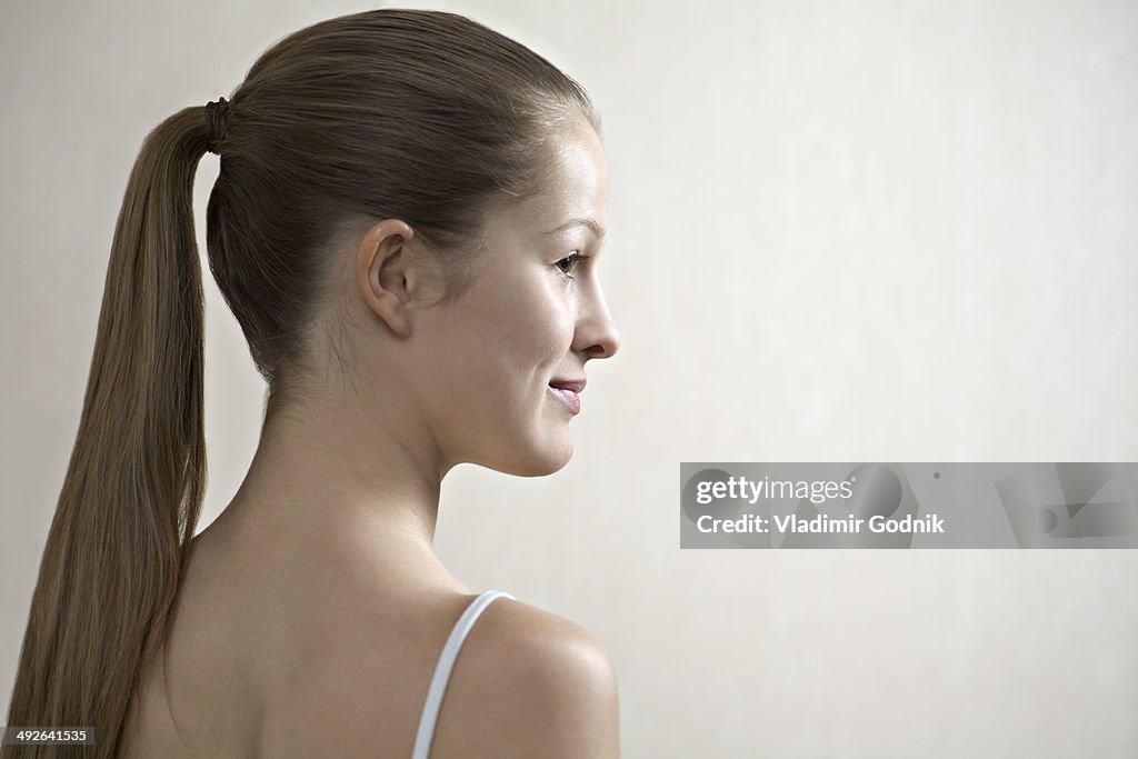 Young woman looking away, smiling