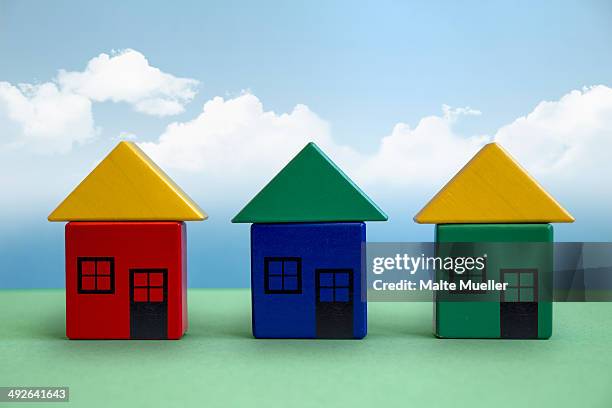 three houses made from toy blocks - building blocks stock illustrations