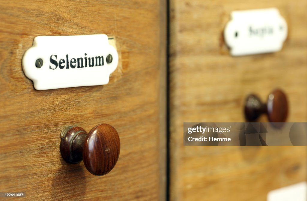 A wooden drawer in pharmacy containing the chemical element Selenium