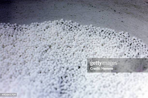 a collection of homeopathic pills in a bowl - homöopathie stock-fotos und bilder