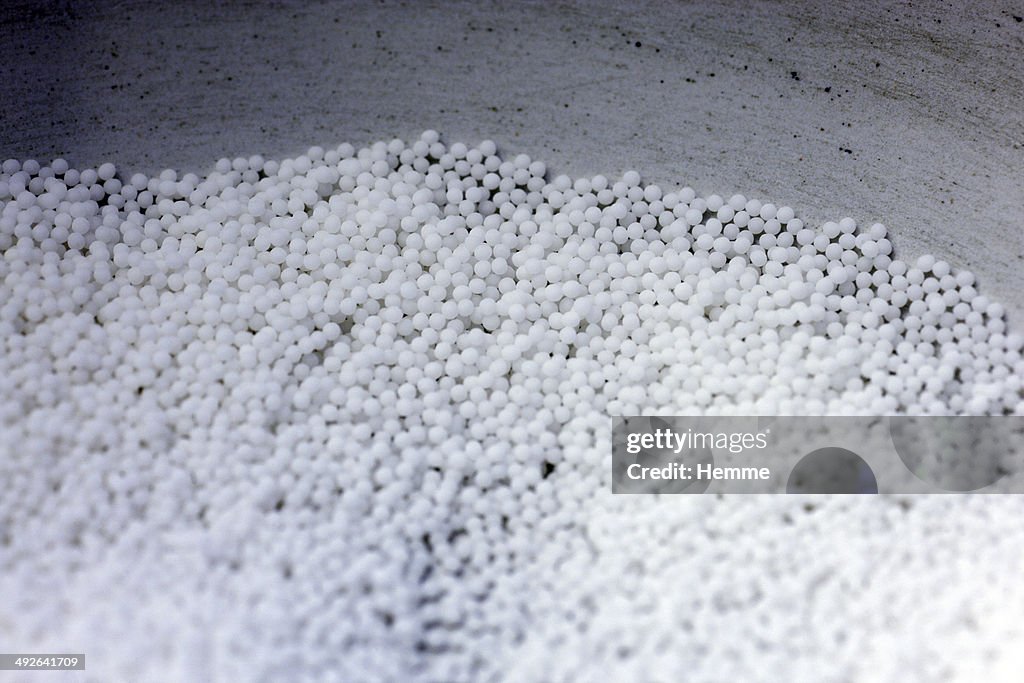 A collection of homeopathic pills in a bowl