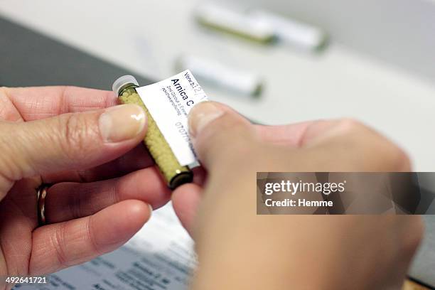 a homeopathic prescription of arnica, which is a perennial herb - medicine label stock pictures, royalty-free photos & images