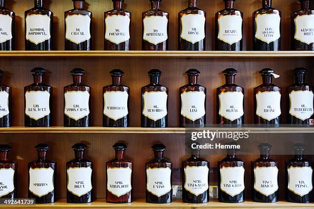 a range of natural spirits, acids and oils in homeopathic pharmacy - stampot stockfoto's en -beelden