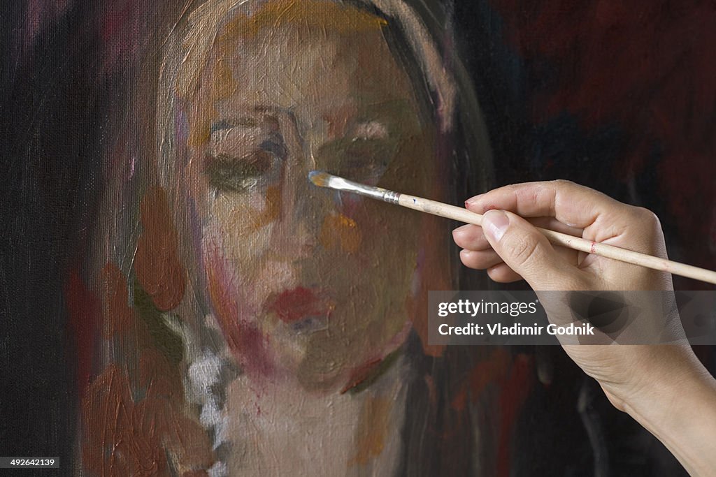 Female artist painting, close-up