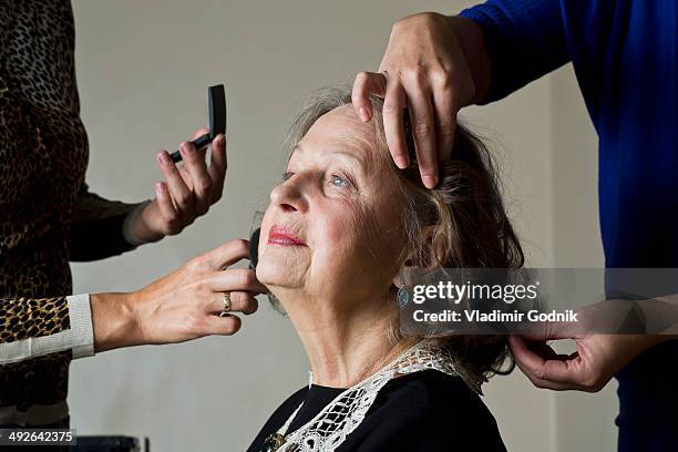 makeup artist applying compact powder on woman face - visagist stockfoto's en -beelden