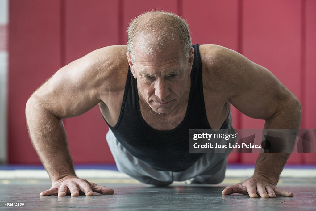 Elderly man doing push-ups