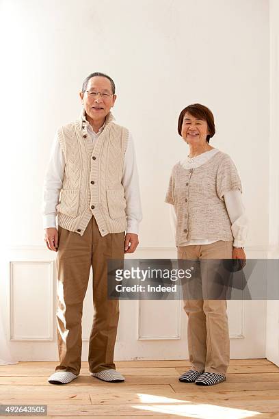 full length of senior couple, portrait - two elderly men dressed in 70's outfits stock pictures, royalty-free photos & images