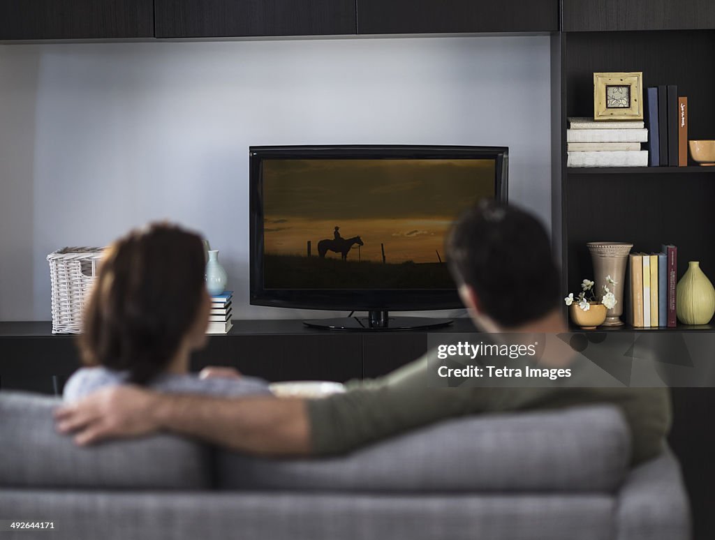 Rear view of couple watching tv, Jersey City, New Jersey, USA