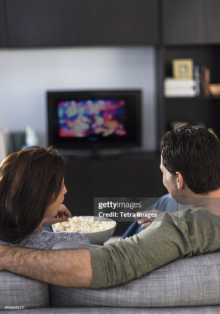 Rear view of couple watching tv, Jersey City, New Jersey, USA