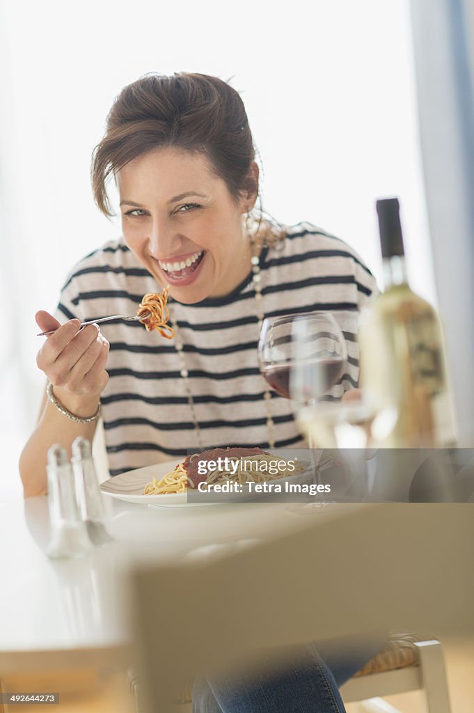 Woman eating spaghetti, Jersey City, New Jersey, USA