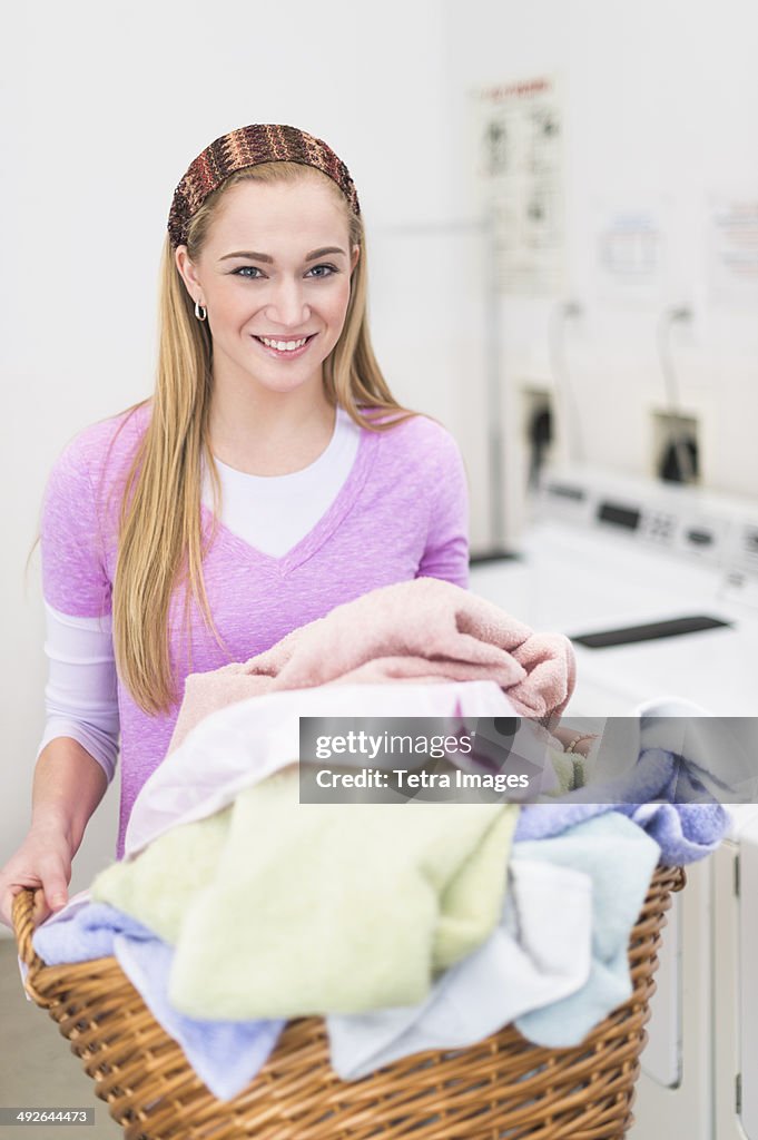 Woman in laundry room, Jersey City, New Jersey, USA