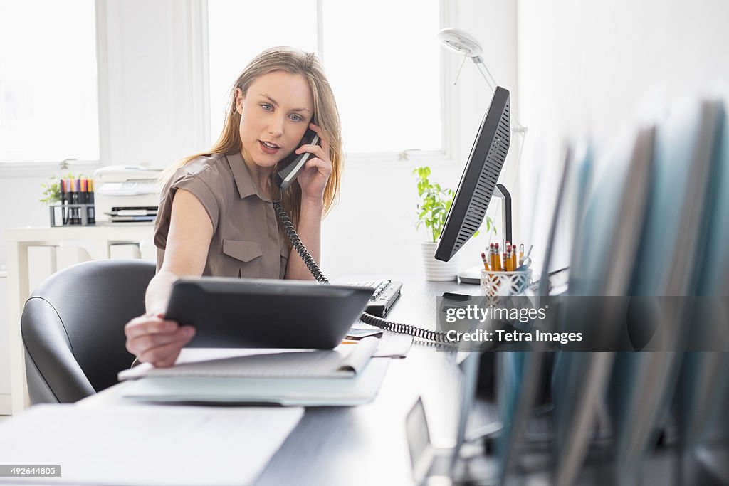 Portrait of young woman working in office, Jersey City, New Jersey, USA