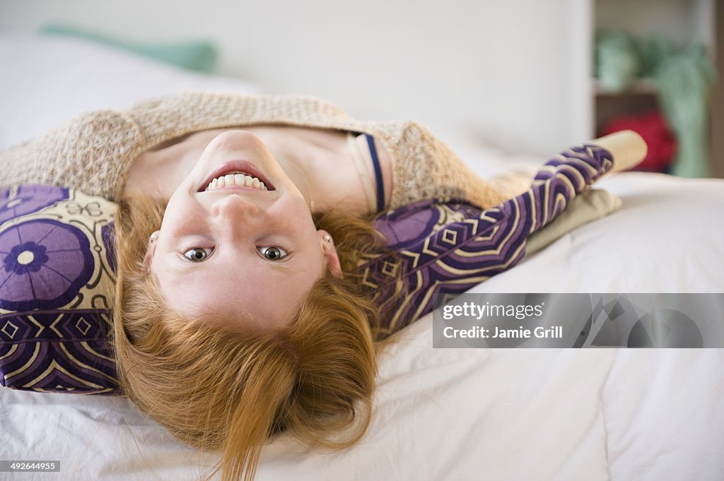 Portrait of girl (12-13) lying on bed, Jersey City, New Jersey, USA