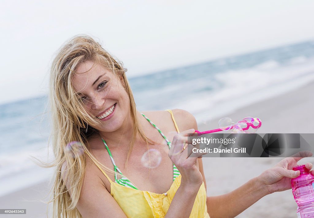 Young woman blowing bubbles, Jupiter, Florida, USA