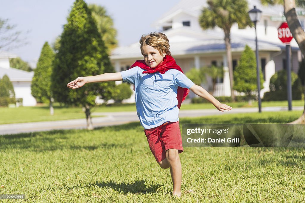 Boy (8-9) running with cape, Jupiter, Florida, USA
