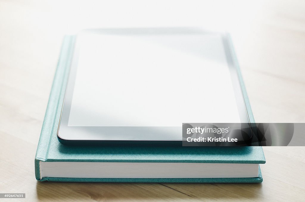 Studio shot of tablet on book