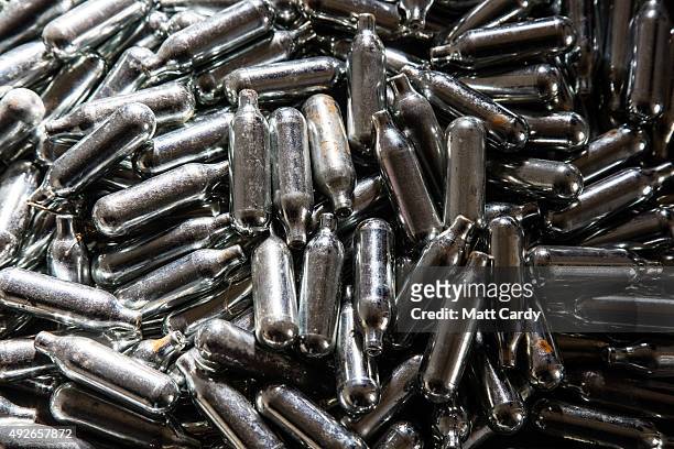 In this photo illustration some of the thousands of empty canisters of nitrous oxide that were collected at the end of a music festival are seen on...