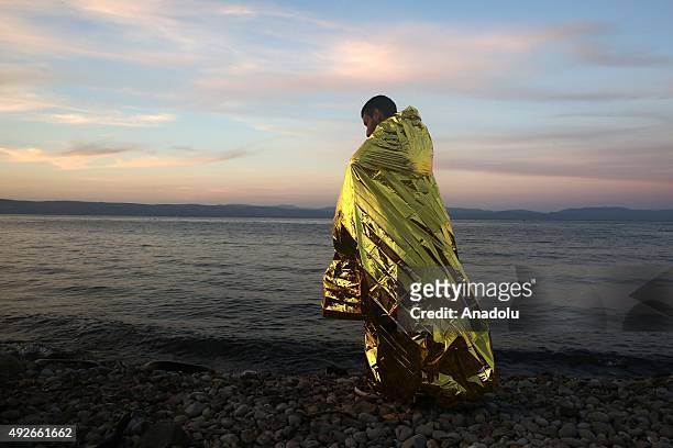 Refugee child is seen after refugees arrived by an inflatable boat on the Greek island of Lesbos after crossing the Aegean sea on October 14, 2015....