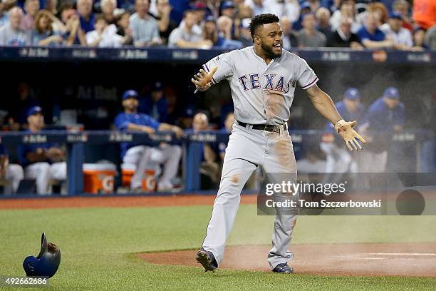 Delino DeShields of the Texas Rangers celebrates after scoring a run in the first inning against the Toronto Blue Jays in game five of the American...