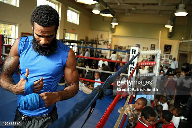 Lamont Peterson removes hand wrap during fighter media workouts in the Alexandria Boxing Club at the Charles Houston Recreation Center on October 14,...
