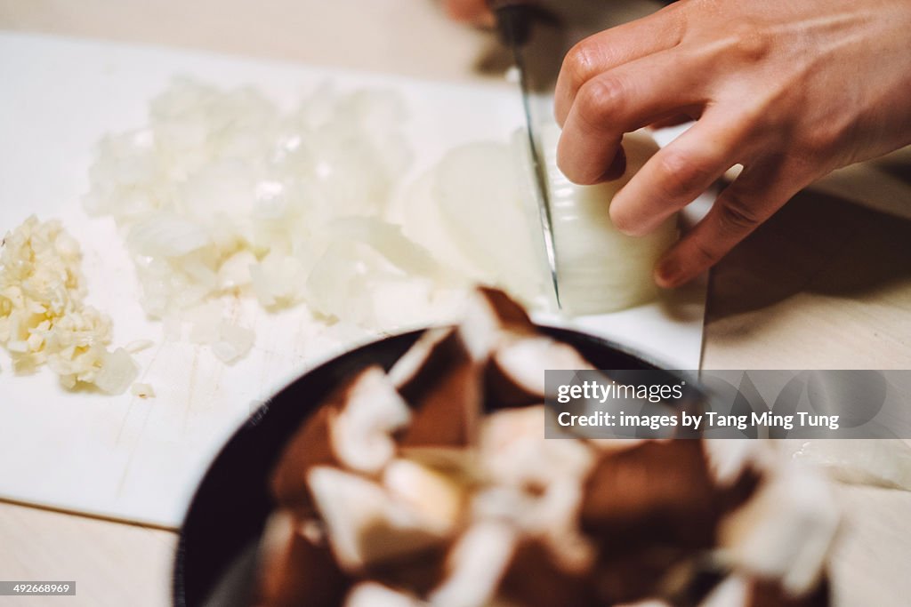 Woman chopping onion, garlic, mushroom