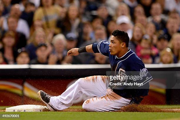 Everth Cabrera of the San Diego Padres slides safely into third on a throwing error in the game against the Miami Marlins at Petco Park on May 10,...