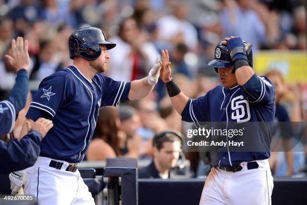 Chase Headley congratulates Everth Cabrera of the San Diego Padres after scoring a run in the game against the Miami Marlins at Petco Park on May 10,...