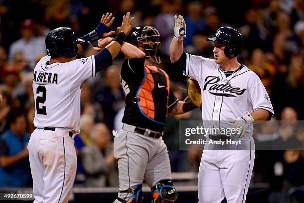 Everth Cabrera congratulates Jedd Gyorko of the San Diego Padres after hitting a grand slam in the game against the Miami Marlins at Petco Park on...