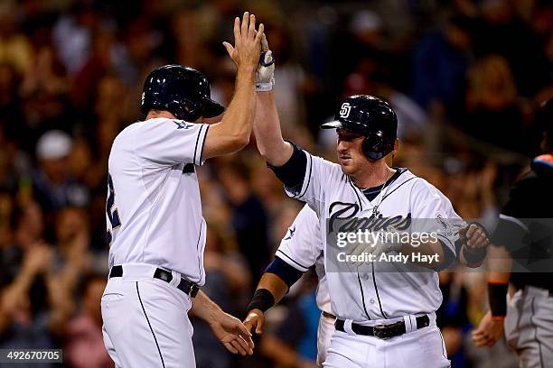 Seth Smith and Everth Cabrera congratulate Jedd Gyorko of the San Diego Padres after hitting a grand slam in the game against the Miami Marlins at...