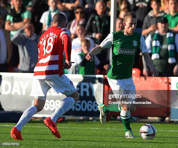 Darian Mackinnon of Hamilton Academical challenges Scott Robertson of Hibernian during the Scottish Premiership Play-off Final First Leg, between...