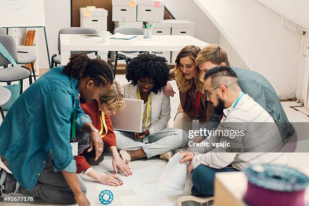 creative designer brainstorming on floor in office. - sitting on ground stock pictures, royalty-free photos & images