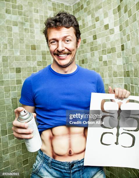 fake muscles - man spraying stock pictures, royalty-free photos & images