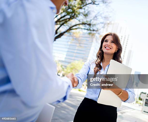 business woman shaking hands - miami business stock pictures, royalty-free photos & images