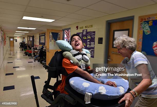 Physical therapist Elaine Lunardi, wheels Michael Keating to his vision therapy session at the Child and Career Development Center on October 8, 2015...