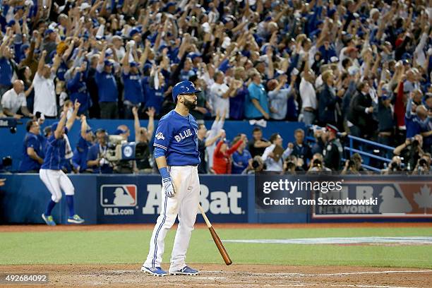 Jose Bautista of the Toronto Blue Jays watches his three-run home run in the seventh inning against the Texas Rangers in game five of the American...