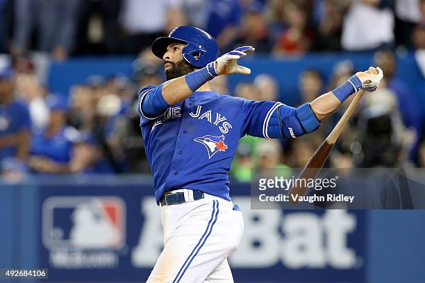 Jose Bautista of the Toronto Blue Jays hits a three-run home run in the seventh inning against the Texas Rangers in game five of the American League...