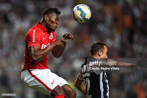 Thiago Ribeiro of Atletico MG and Paulao of Internacional battle for the ball during a match between Atletico MG and Internacional as part of...