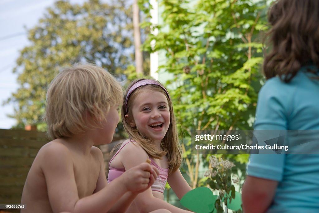 Three children talking outside