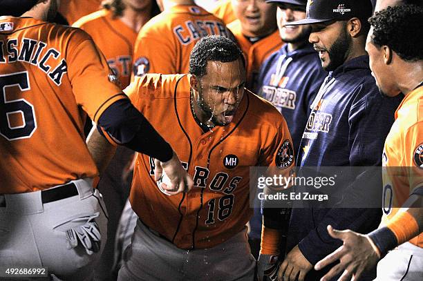 Luis Valbuena of the Houston Astros celebrates in the dugout after hitting a two-run home run in the second inning against the Kansas City Royals...