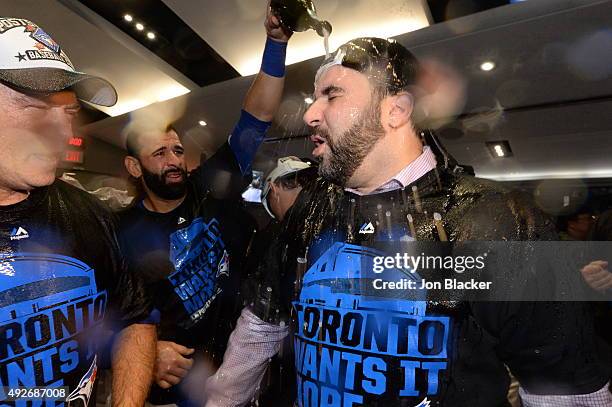 Alex Anthopoulos, General Manager of the Toronto Blue Jays celebrates in the locker room with his team after winning Game 5 of the ALDS against the...